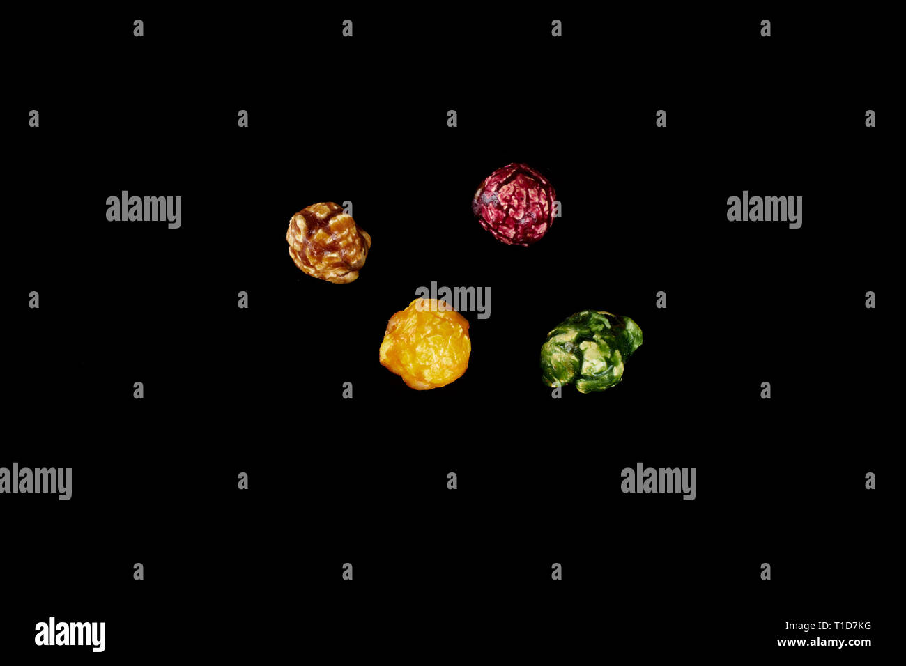 multicolored caramel popcorn on a black background. Stock Photo