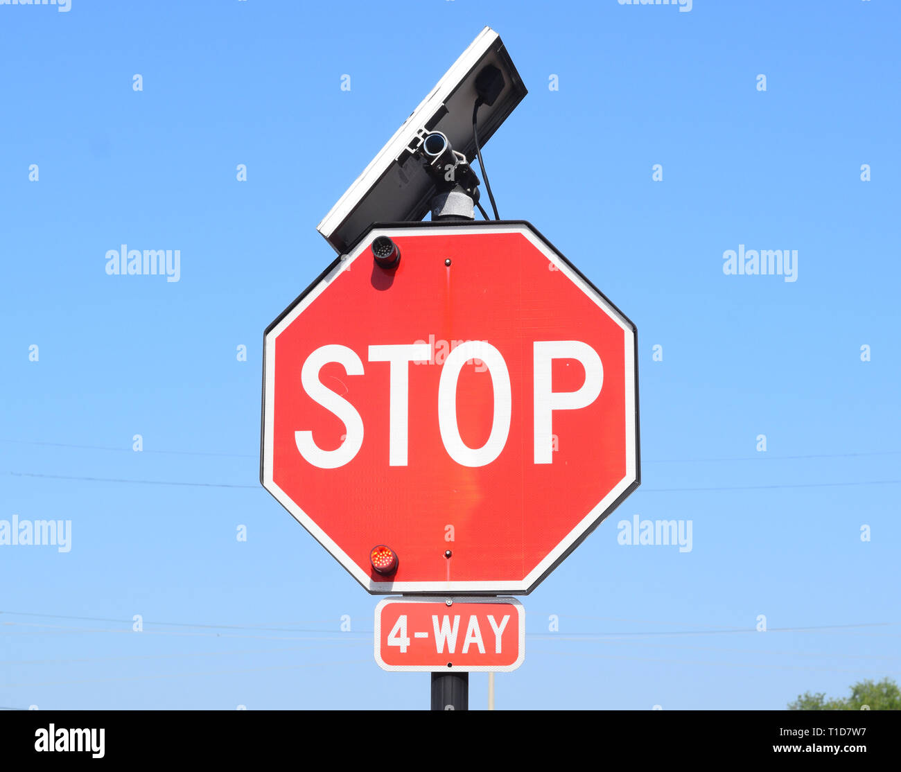 Stop sign with solar panel on top of the sign Stock Photo