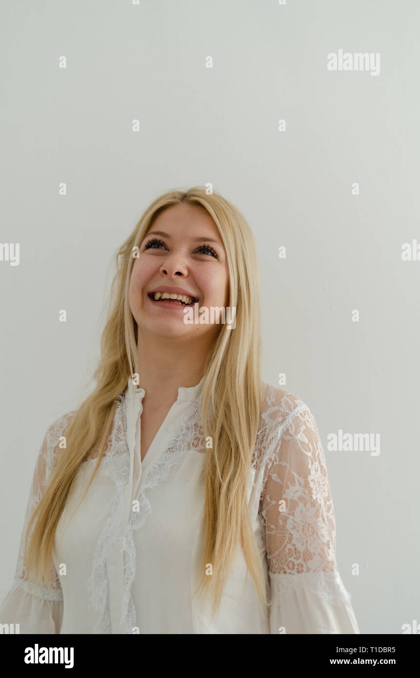 Portrait of wonderful young woman with long blond hair and green eyes ...