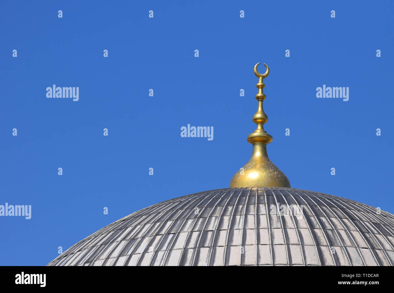 Mosque Dome With Crescent Moon Symbol Against Blue Sky Stock Photo