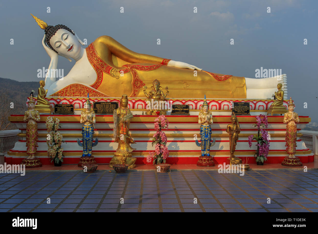 Huge statue of reclining Buddha at Wat Phra That Doi Kham in Chiang Mai Stock Photo