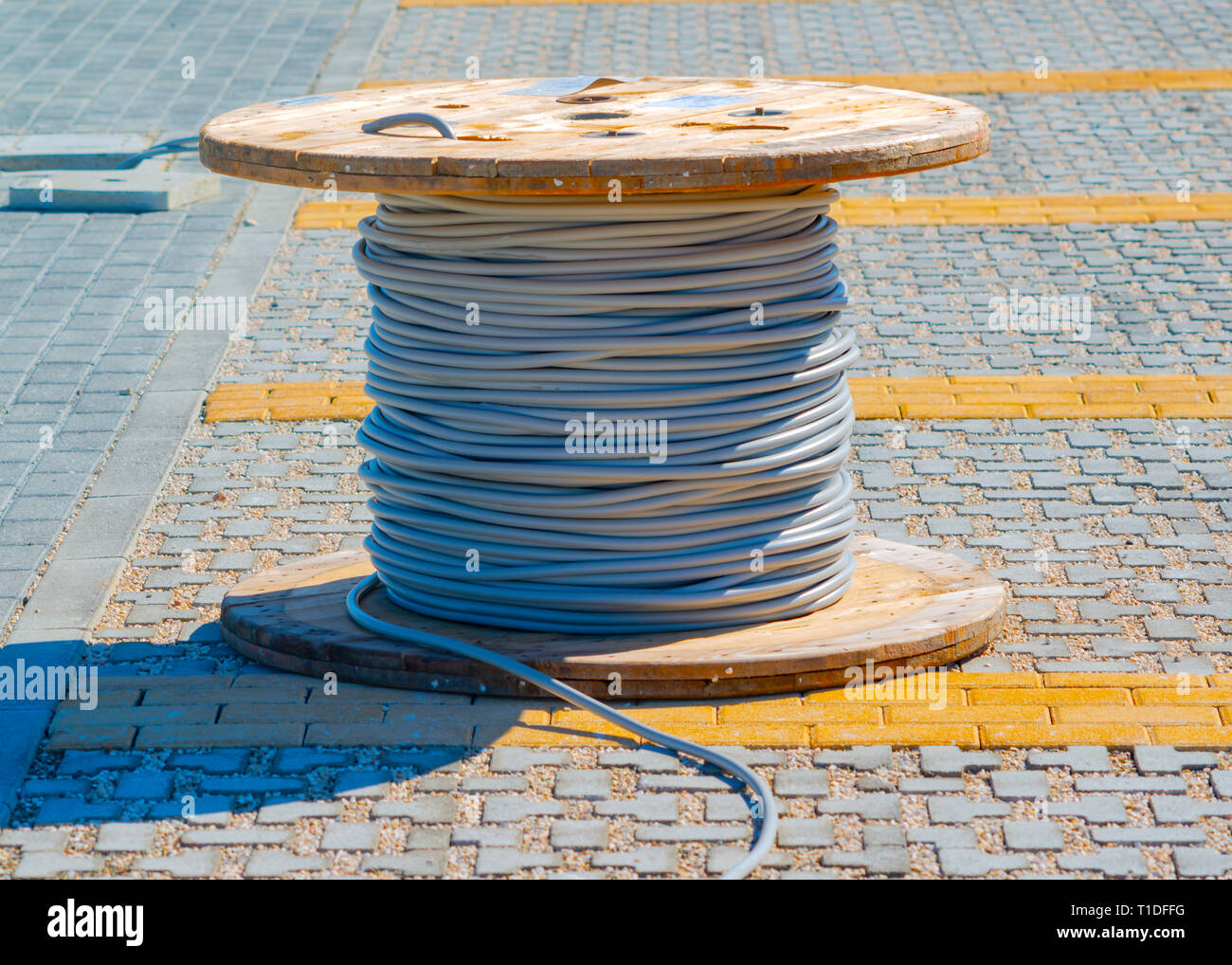 wire electric cable with wooden coil of electric cable waiting to be