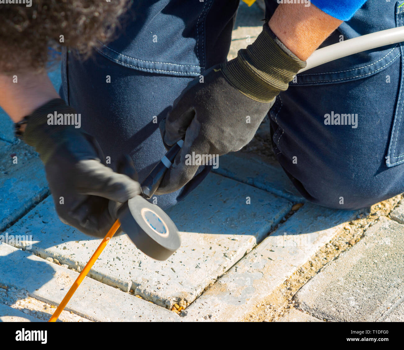 Technicians connection of an electrical cable break Stock Photo