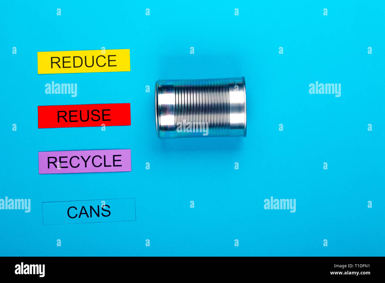 Recycle concept showing reduce, reuse & recycle with cans on a blue ...