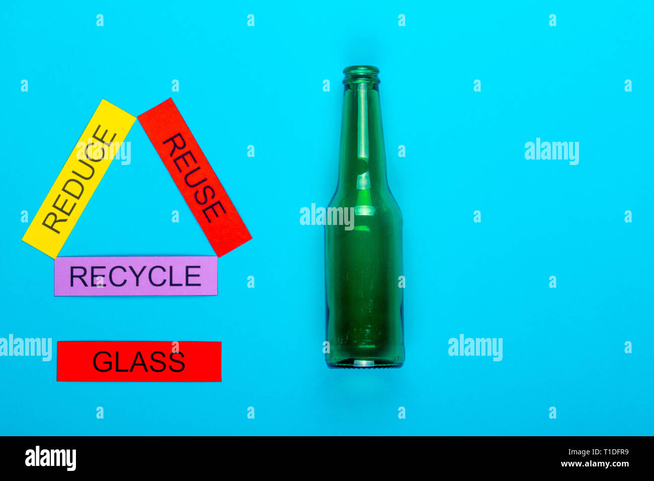 Recycle concept showing reduce, reuse & recycle with glass on a blue ...