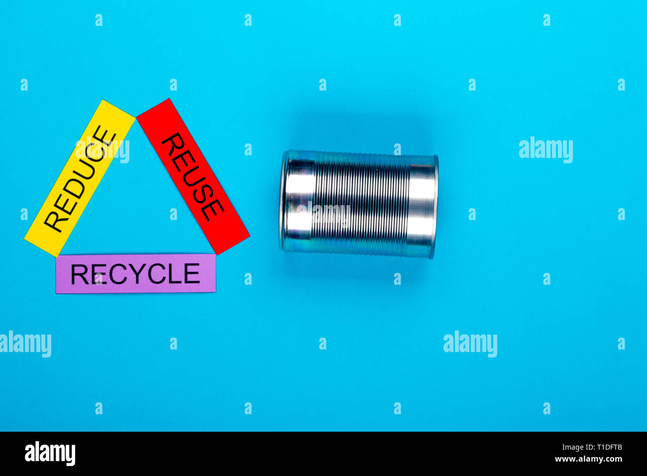 Recycle concept showing reduce, reuse & recycle with cans on a blue ...