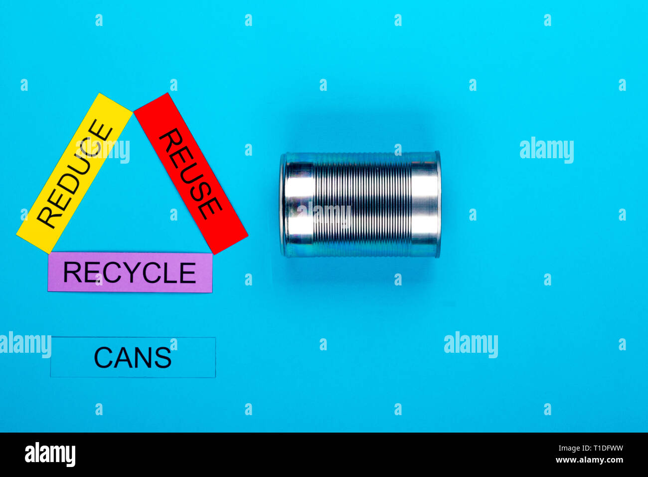 Recycle concept showing reduce, reuse & recycle with cans on a blue ...