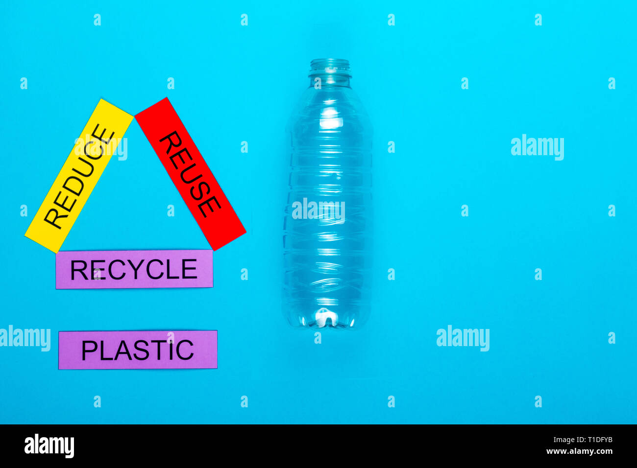 Recycle concept showing reduce, reuse & recycle with plastic on a blue ...