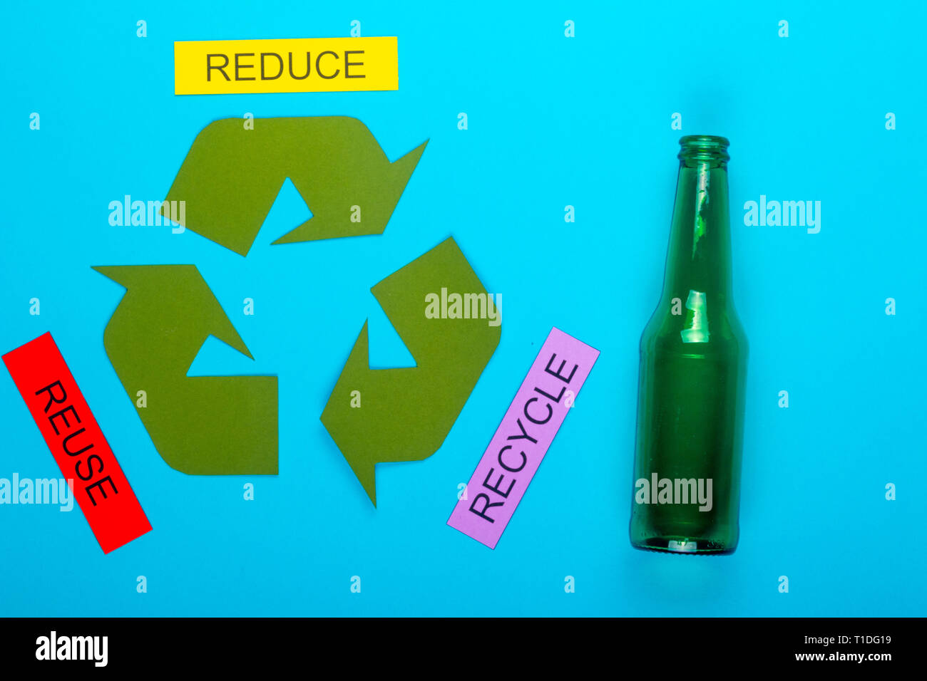 Recycle concept showing the green recycle logo with reduce, reuse, recycle  & glass on a blue background Stock Photo - Alamy