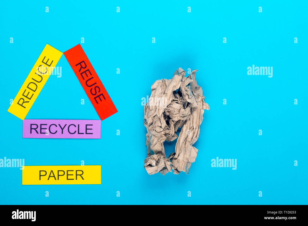 Recycle concept showing reduce, reuse & recycle with paper on a blue ...
