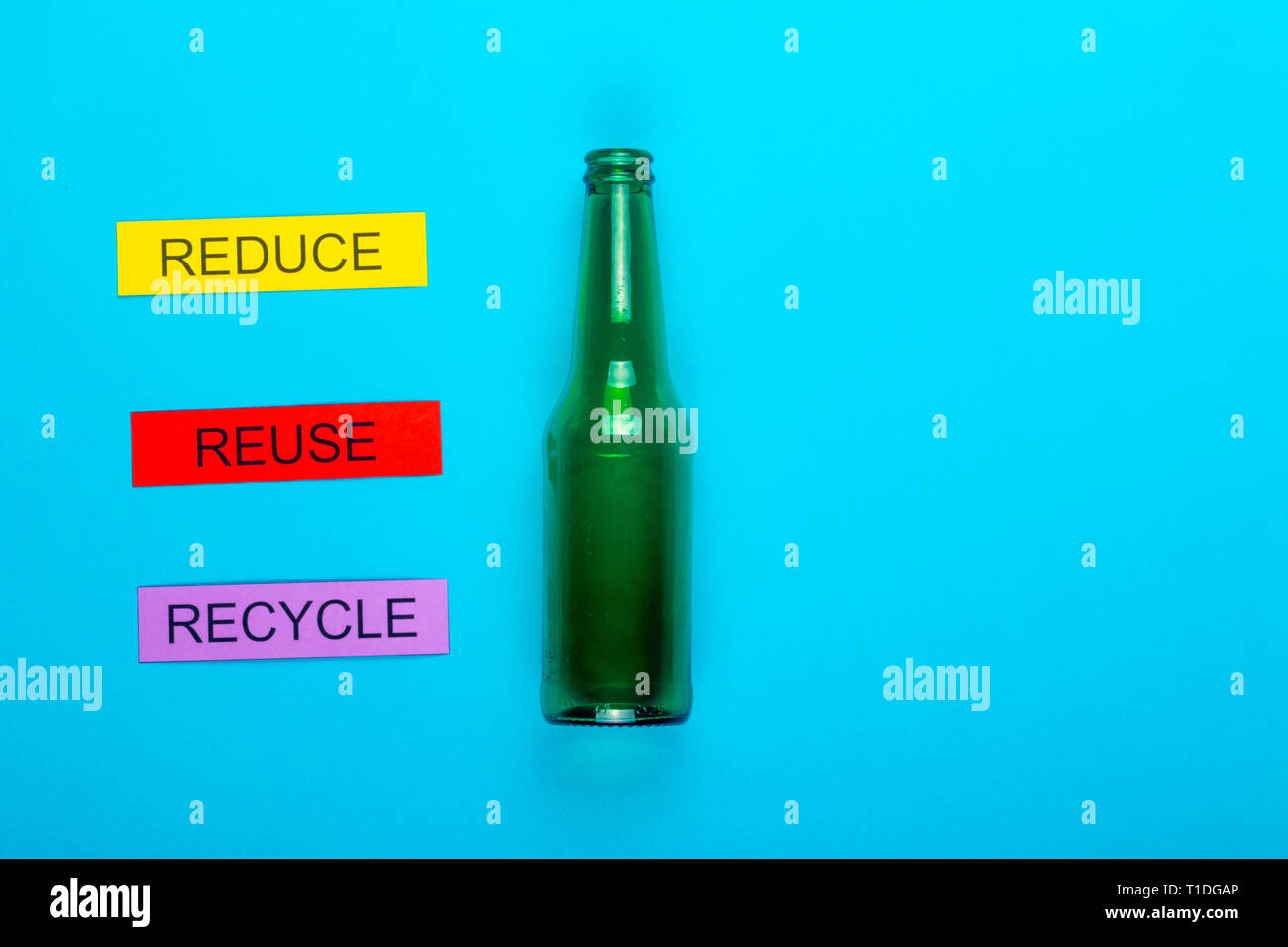 Recycle concept showing reduce, reuse & recycle with glass on a blue ...