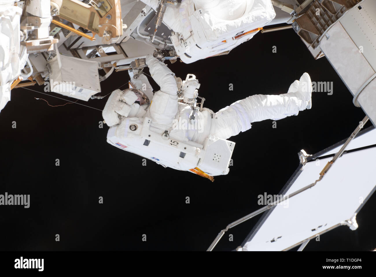Expedition 59 NASA astronaut Nick Hague works on the power supply during a spacewalk outside the International Space Station March 22, 2019 in Earth Orbit. Astronauts McClain and Hague spent six-hours and 39-minutes outside the space station to upgrade the orbital complex's power storage capacity. Stock Photo