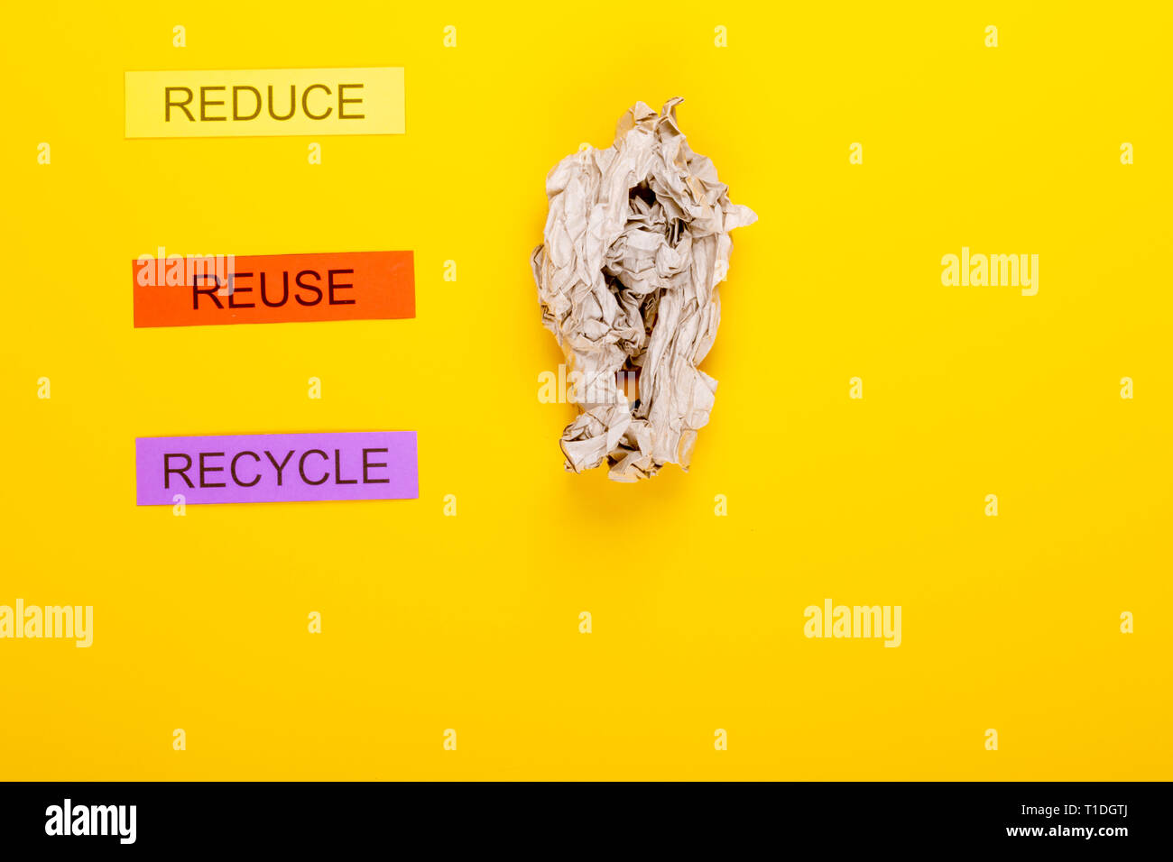 Recycling concept showing reduce, reuse, recycle & paper on a yellow ...