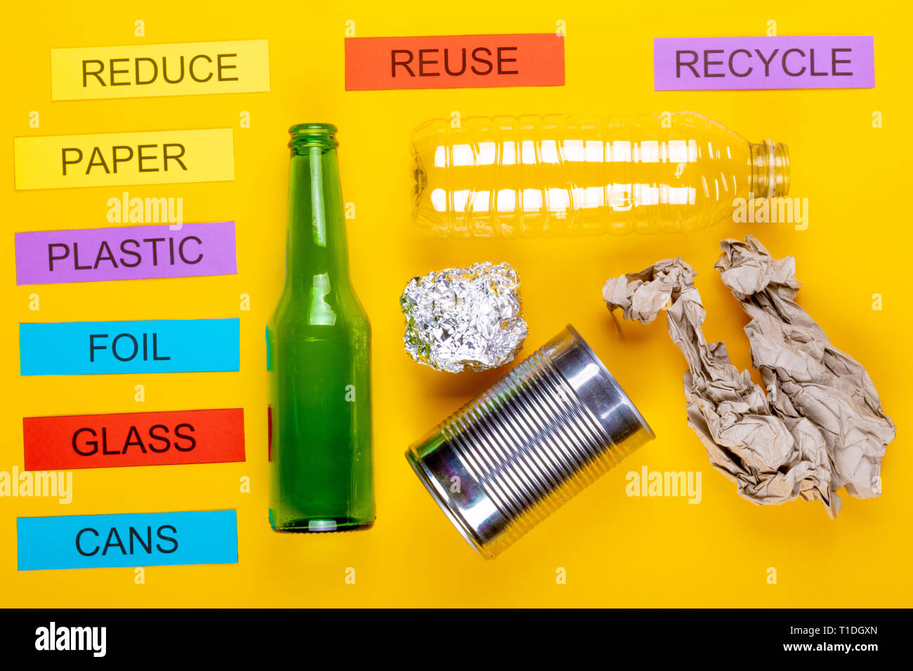 Recycling concept showing paper,foil, cans, glass, paper & reduce