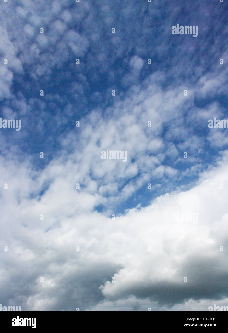 Blue cloudy dramatic sky background with white clouds Stock Photo - Alamy
