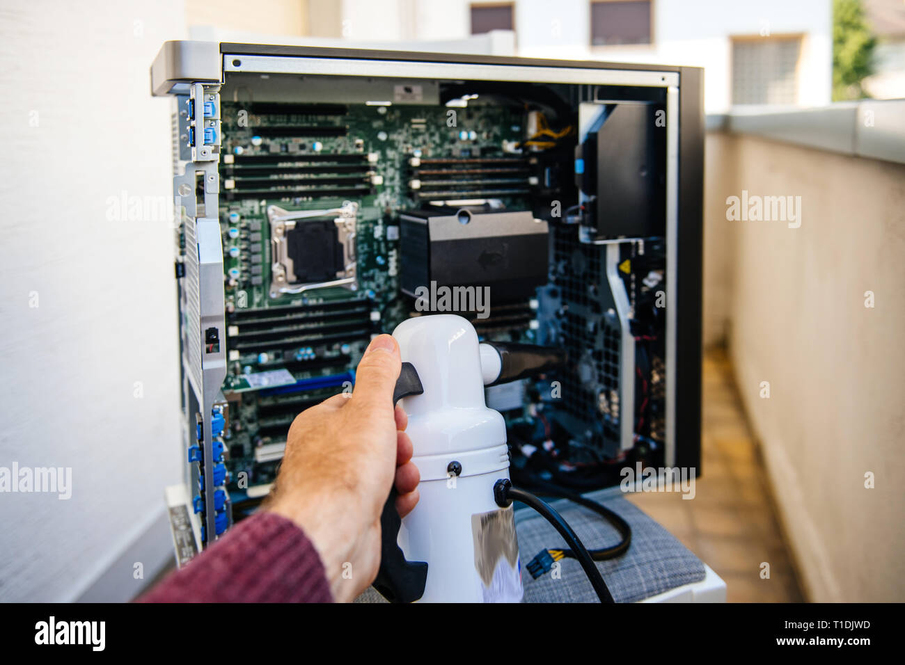 Man hand holding vacuum electric duster pump preparing to clean