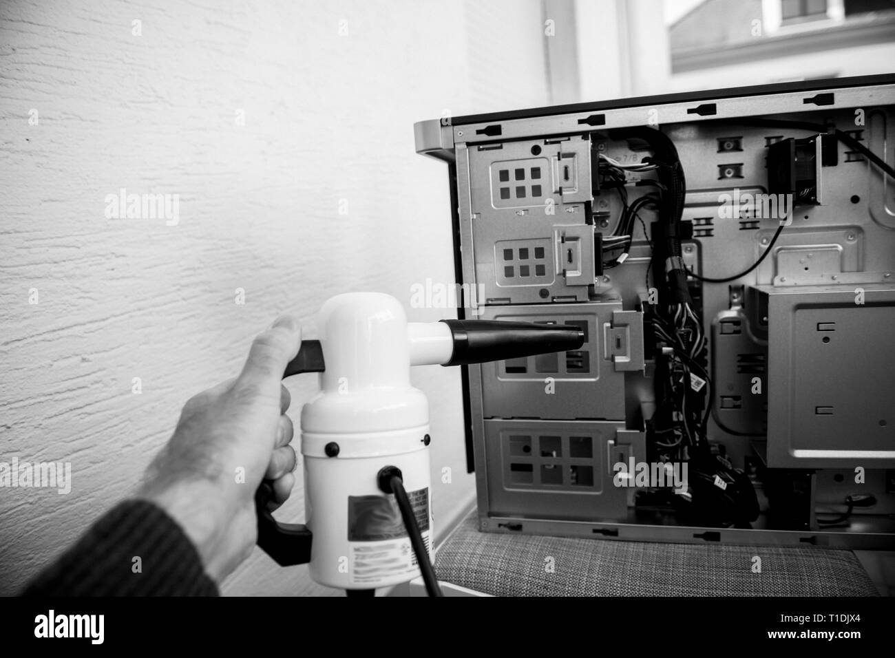 Man hand holding vacuum electric duster pump preparing to clean