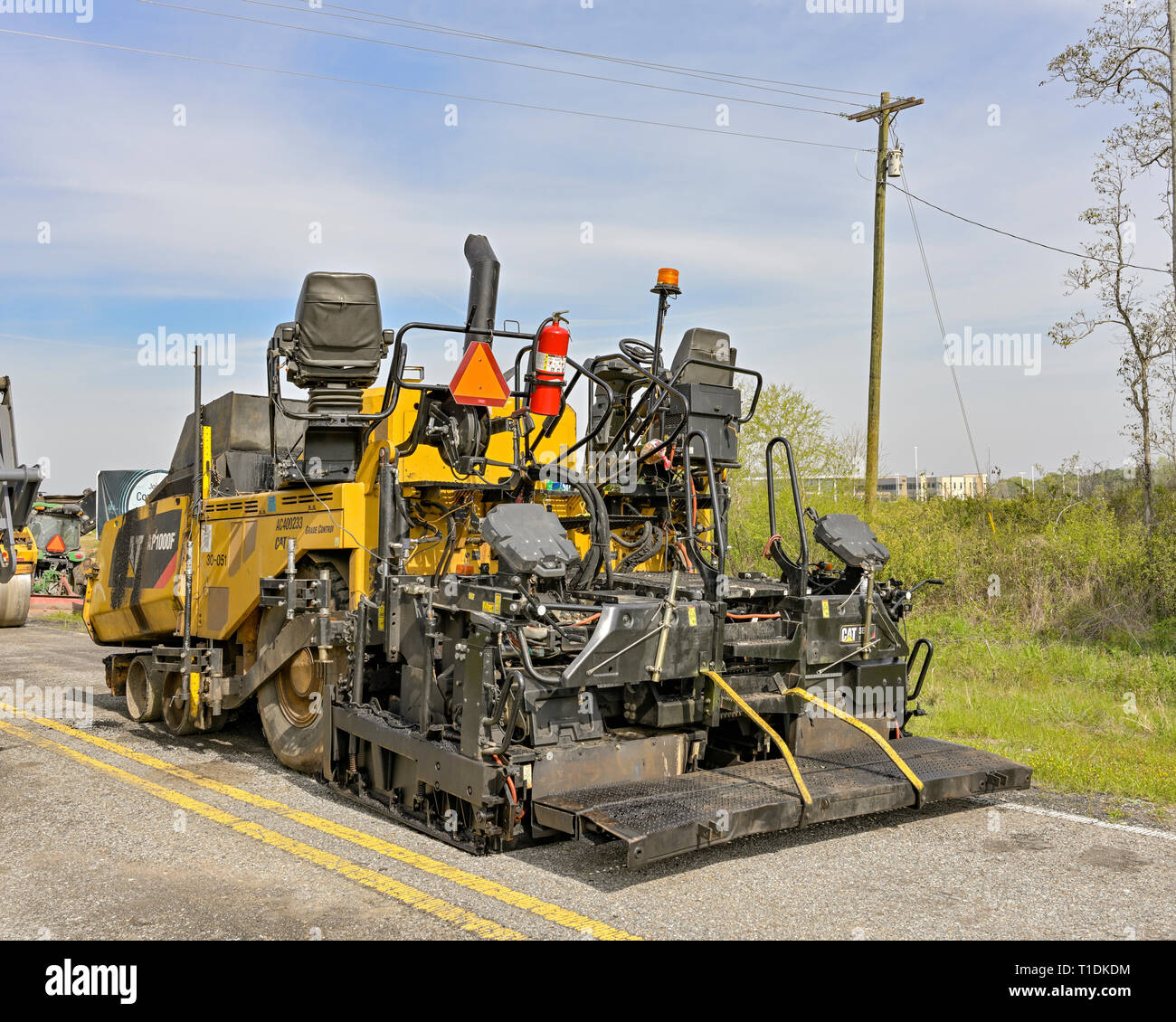 Cat AP100F wheeled paving machine or asphalt paving machine parked and idle in Montgomery Alabama, USA. Stock Photo