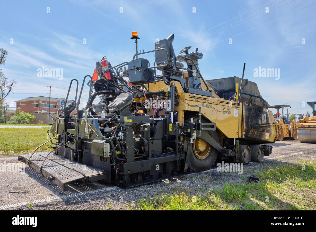 Cat AP100F wheeled paving machine or asphalt paving machine parked and idle in Montgomery Alabama, USA. Stock Photo