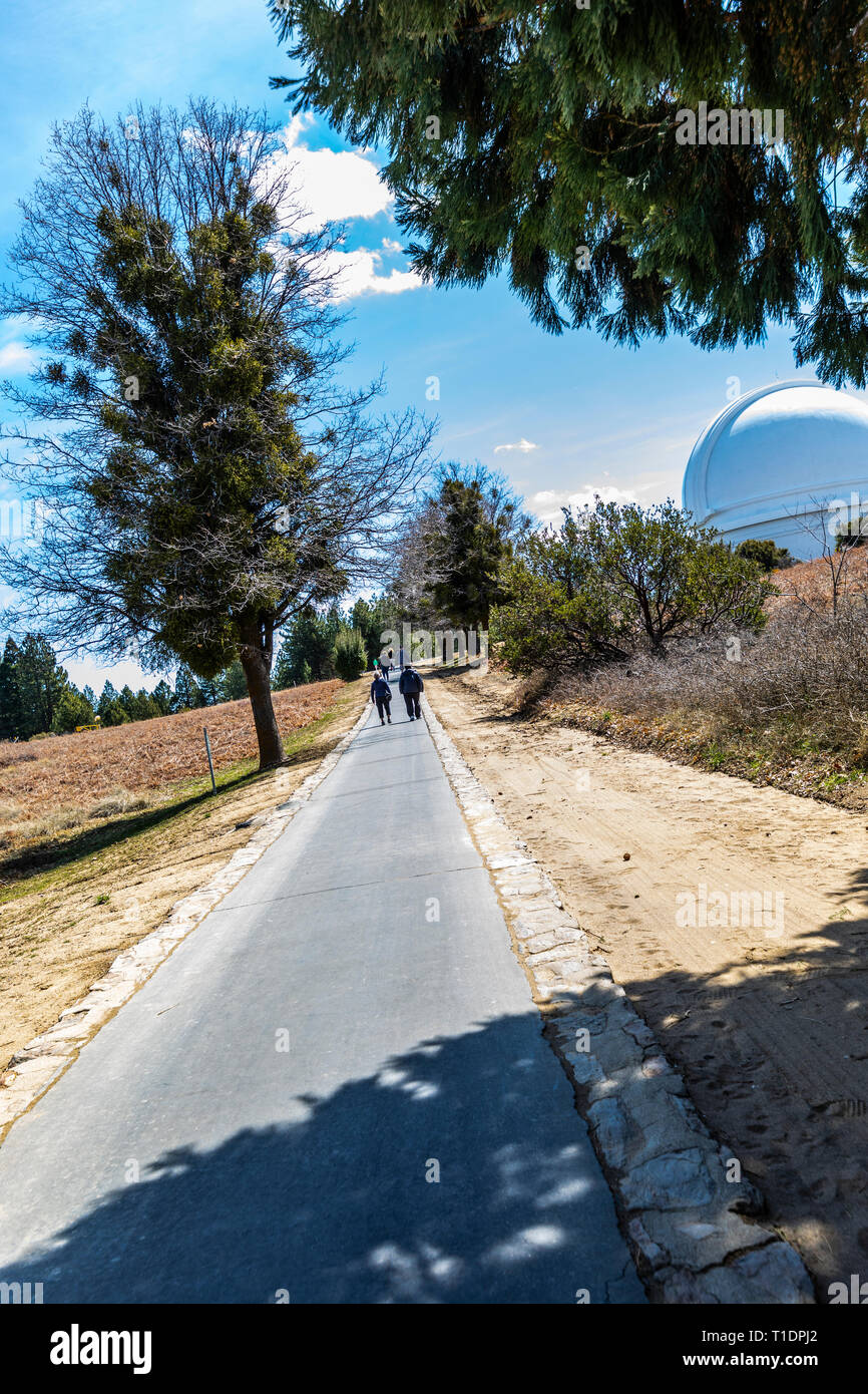 An Elderly couple walk towards Mount Palomar observatory In California Stock Photo