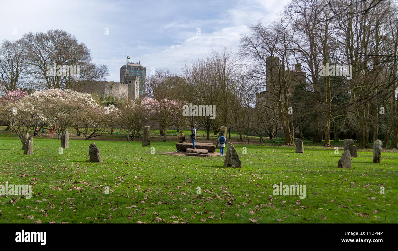The modern Gorsedd Stone circle in Bute Park with Cardiff Castle in the