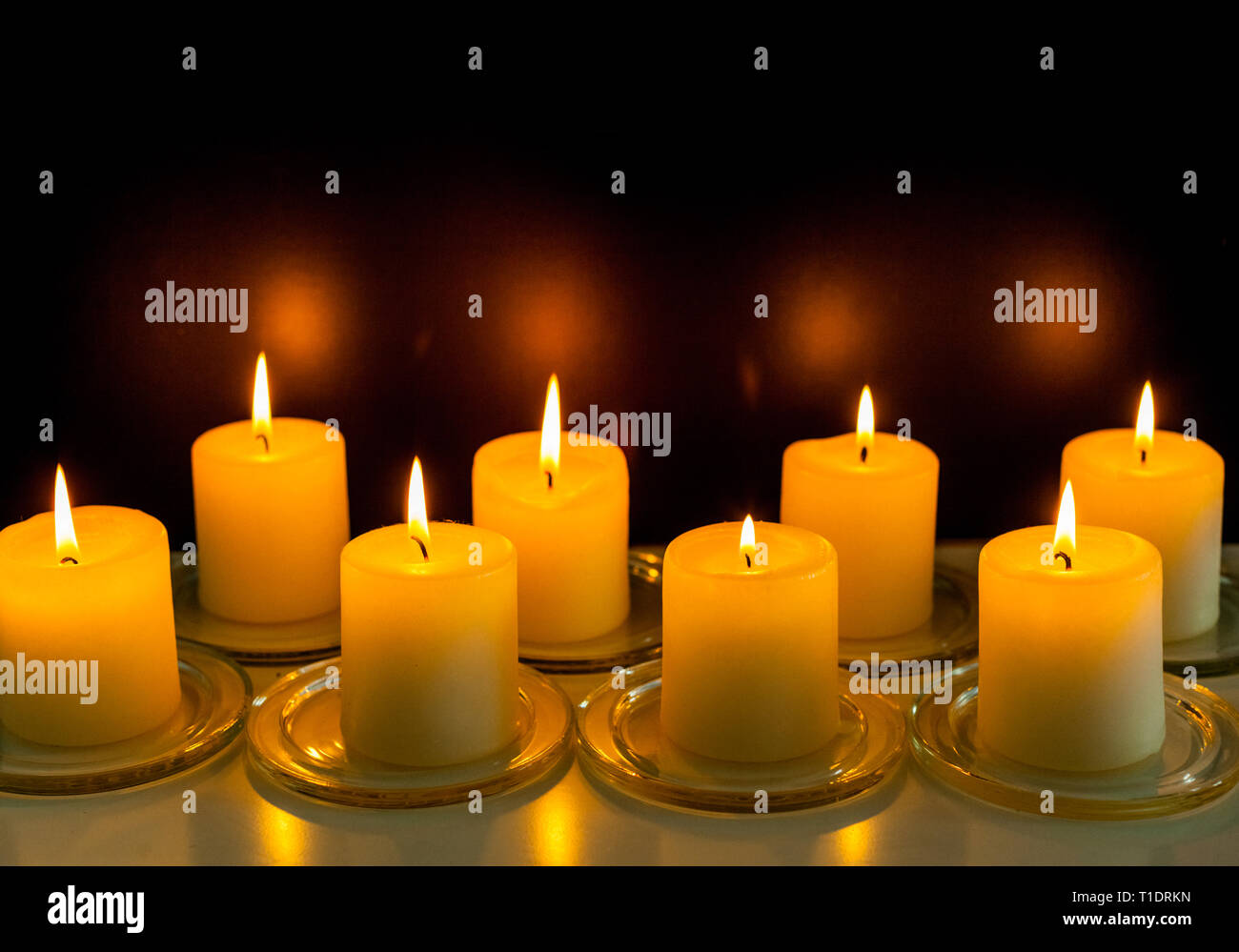 closeup to burning candles in darkness Stock Photo Alamy