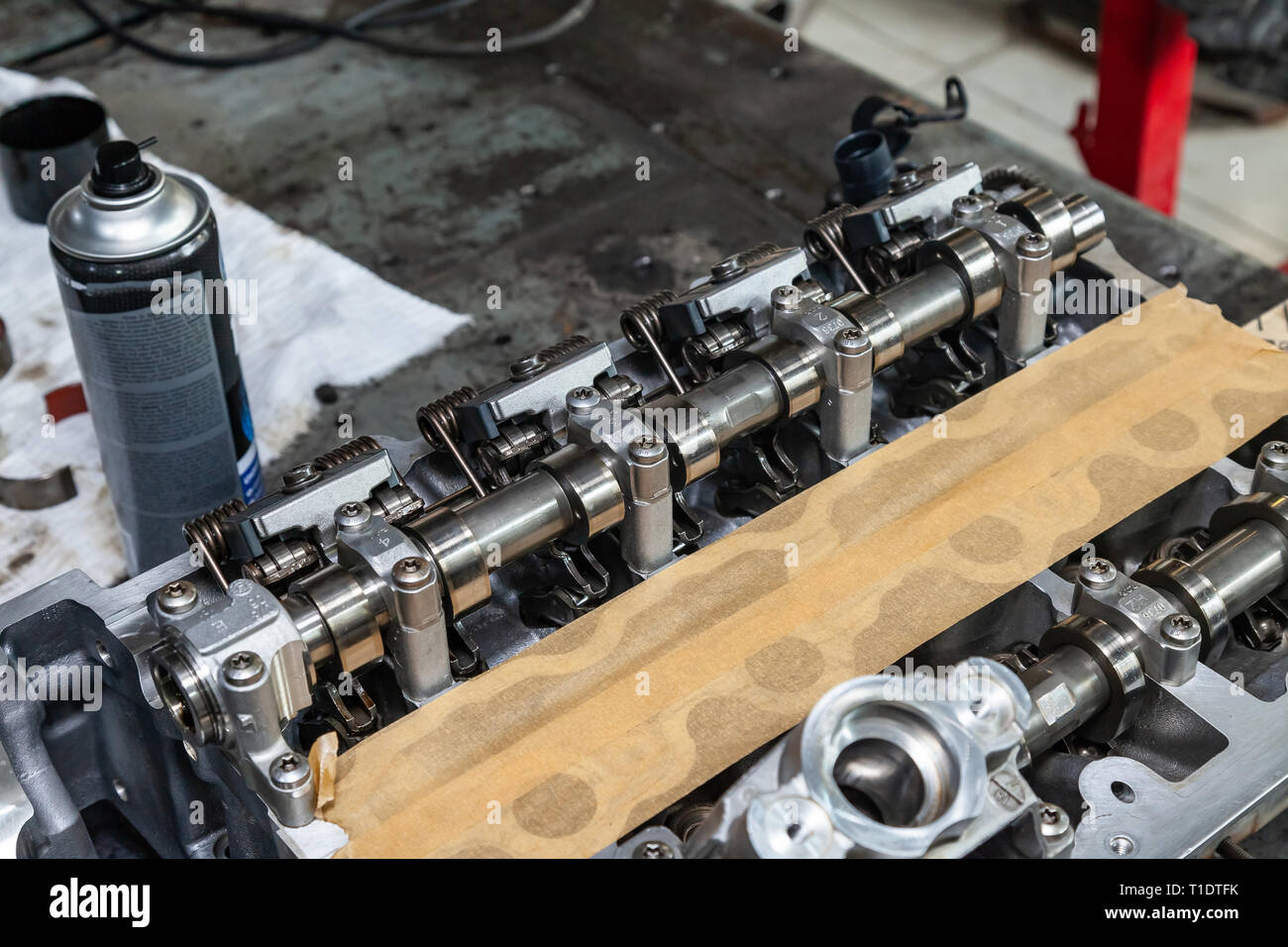 A four-cylinder engine with new camshaft dissembled and removed from car on a workbench in a vehicle repair workshop. Auto service industry. Stock Photo