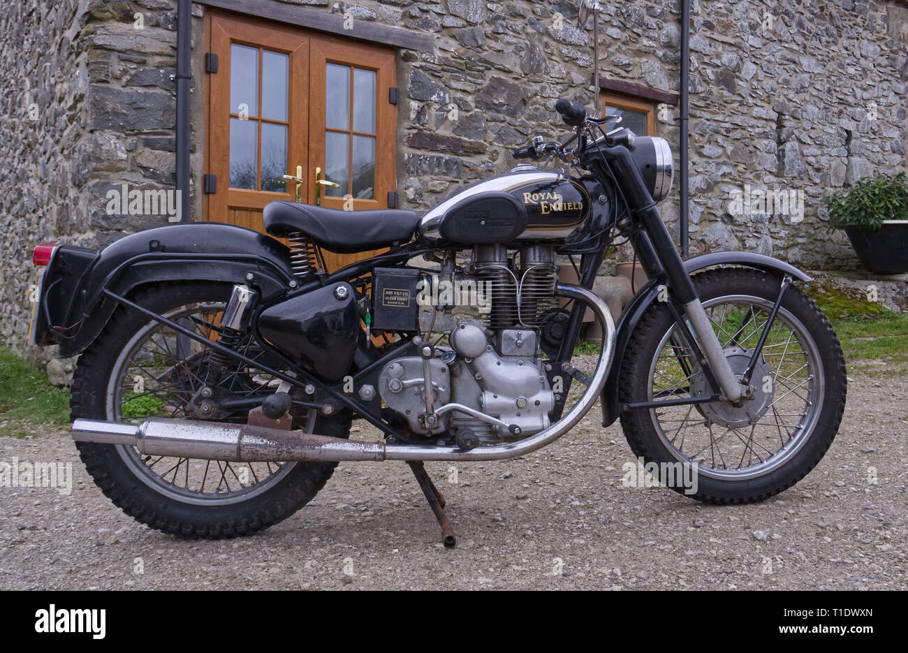 Royal Enfield 350cc Bullet motorcycle parked outside an old stone