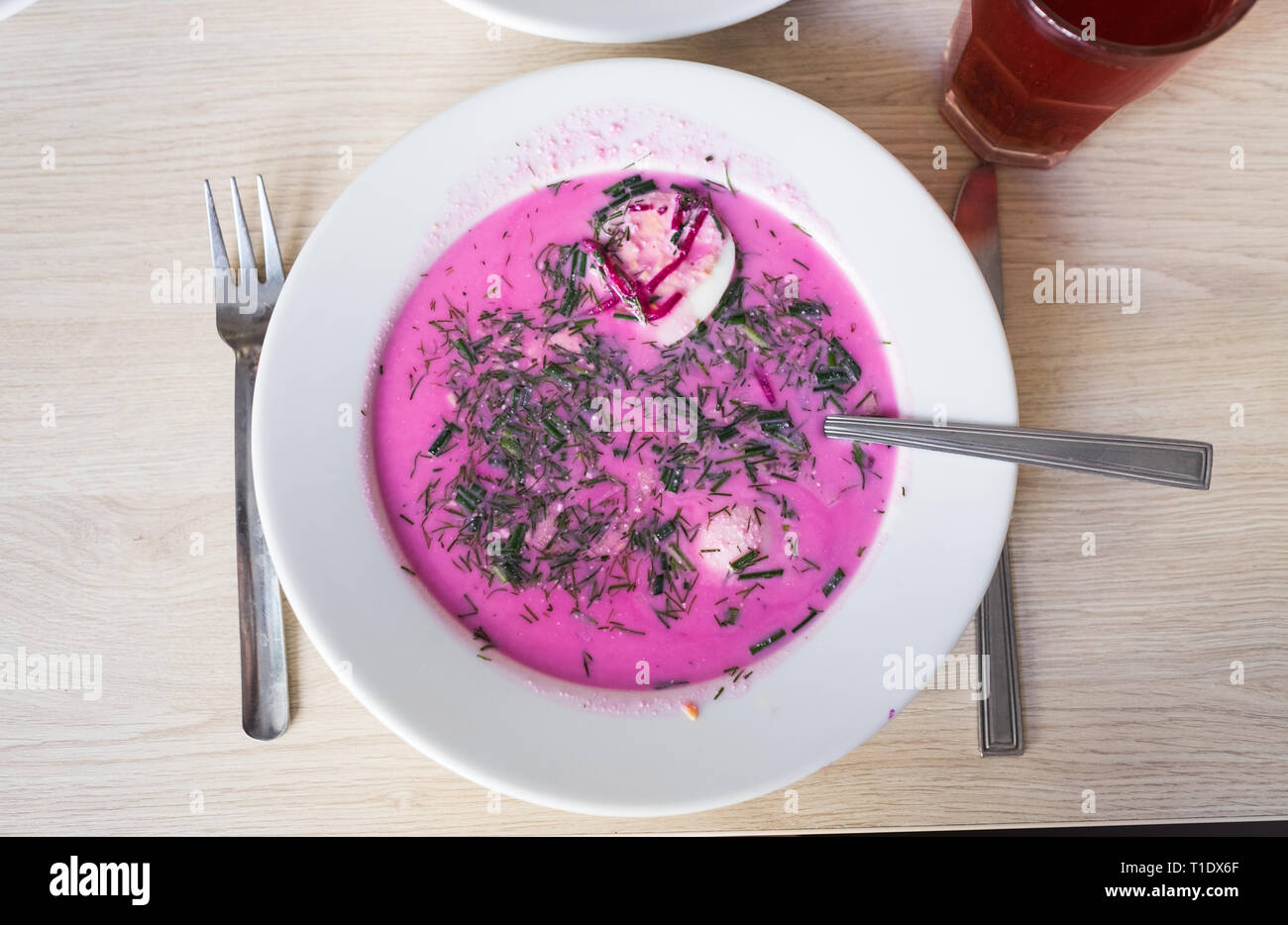 A bowl of Polish chlodnik, a delicious cold soup made with beetroot, sour cream, hard boiled egg, and fresh herbs, served at Bar Bambino, a milk bar. Stock Photo