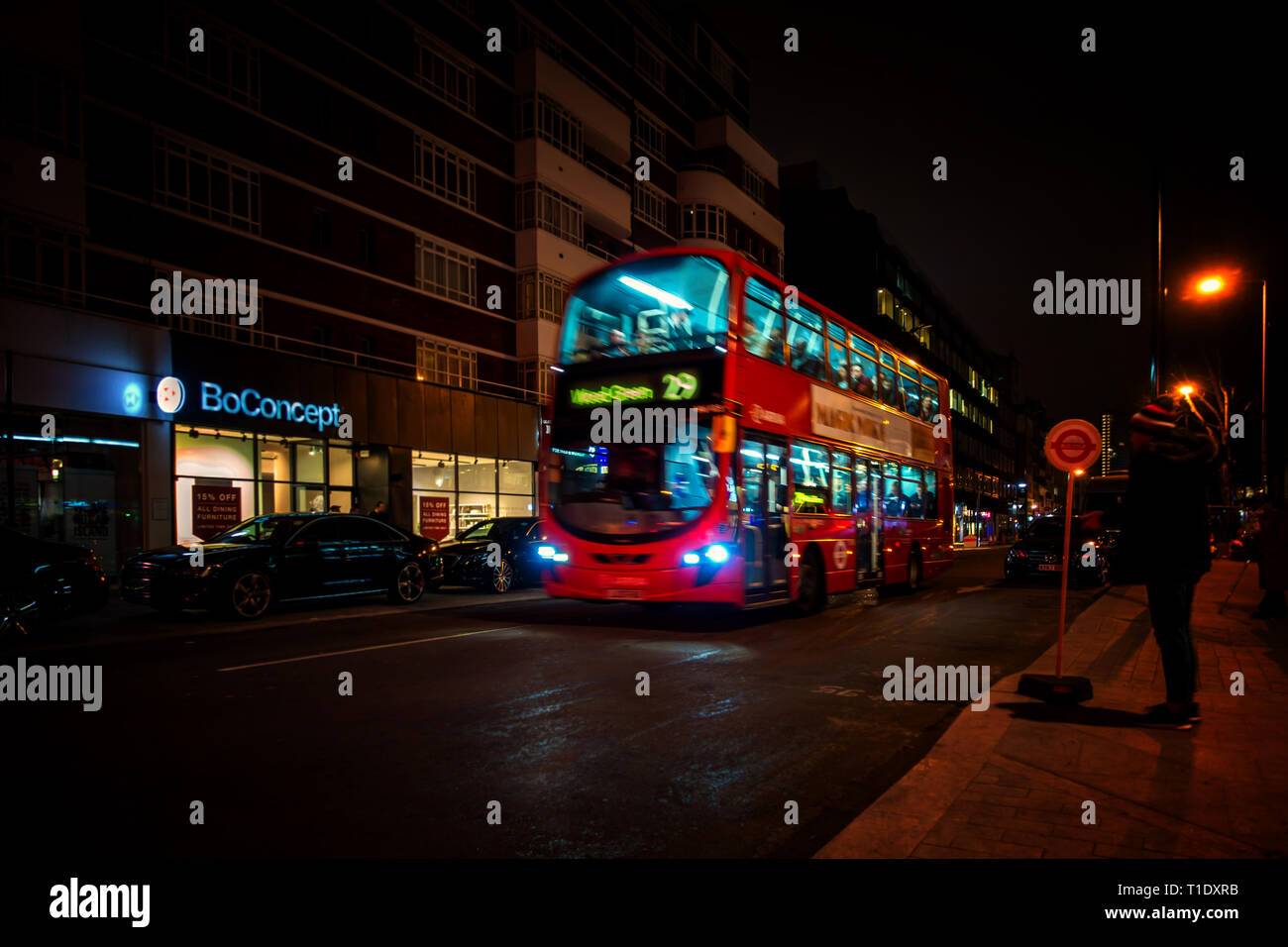 Blurred image taken at night of one of the late night last London buses on route through the city centre Stock Photo