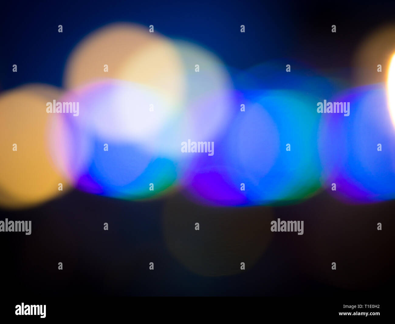 Background formed by blurred reflections of colored lights Stock Photo