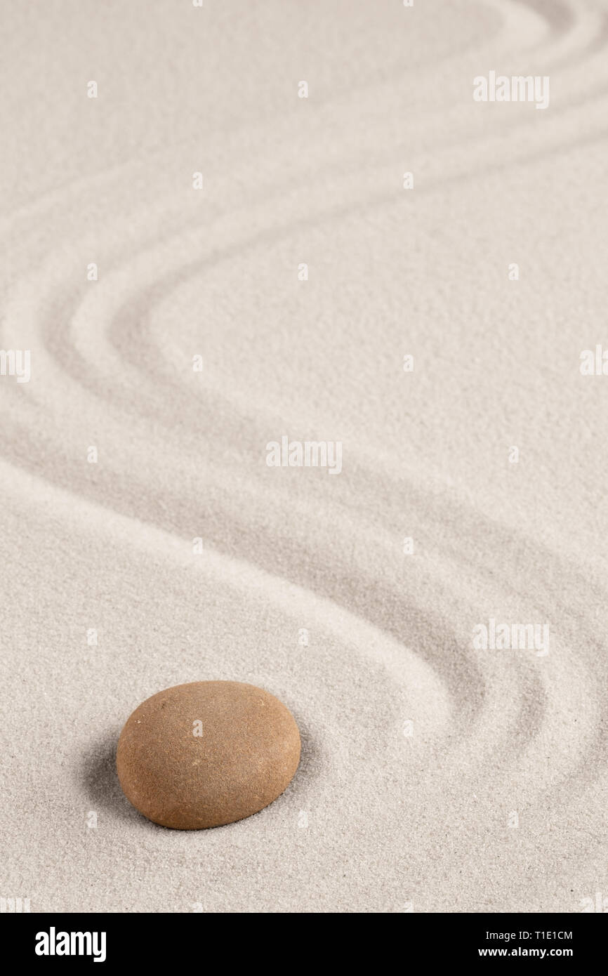 Spa wellness for inner life and spiritual health. Zen meditation stone for relaxation. Concept for purity balance and harmony. Background with raked s Stock Photo