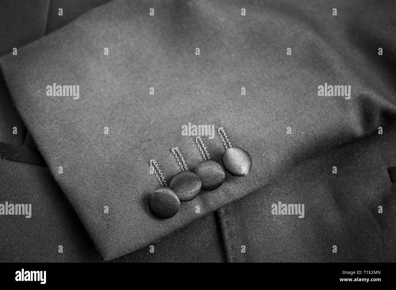 Buttons on the left sleeves of a grey blazer suit Stock Photo