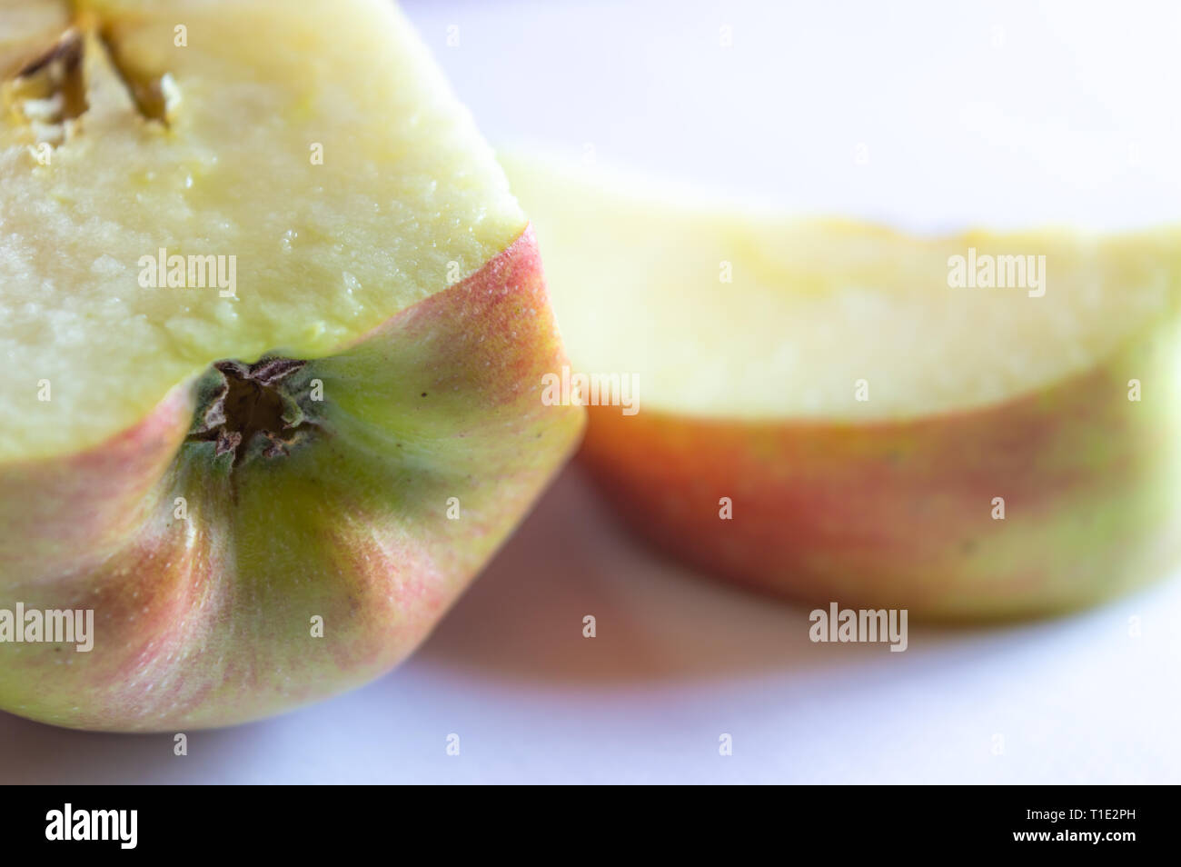 A half apple with an apple slice shallow depth of view Stock Photo