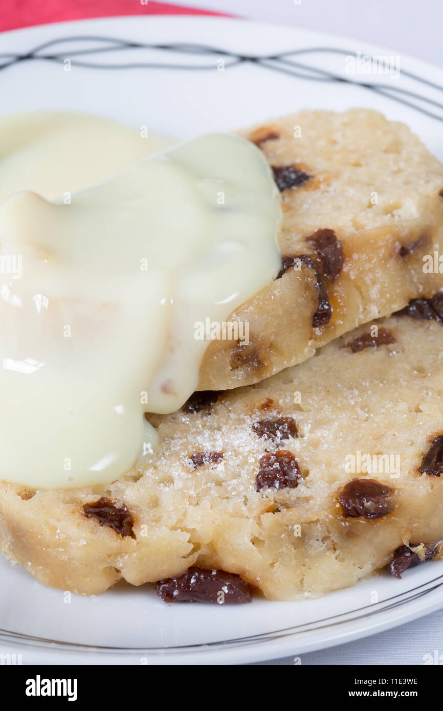 Traditional classic English pudding of Spotted dick with custard sauce