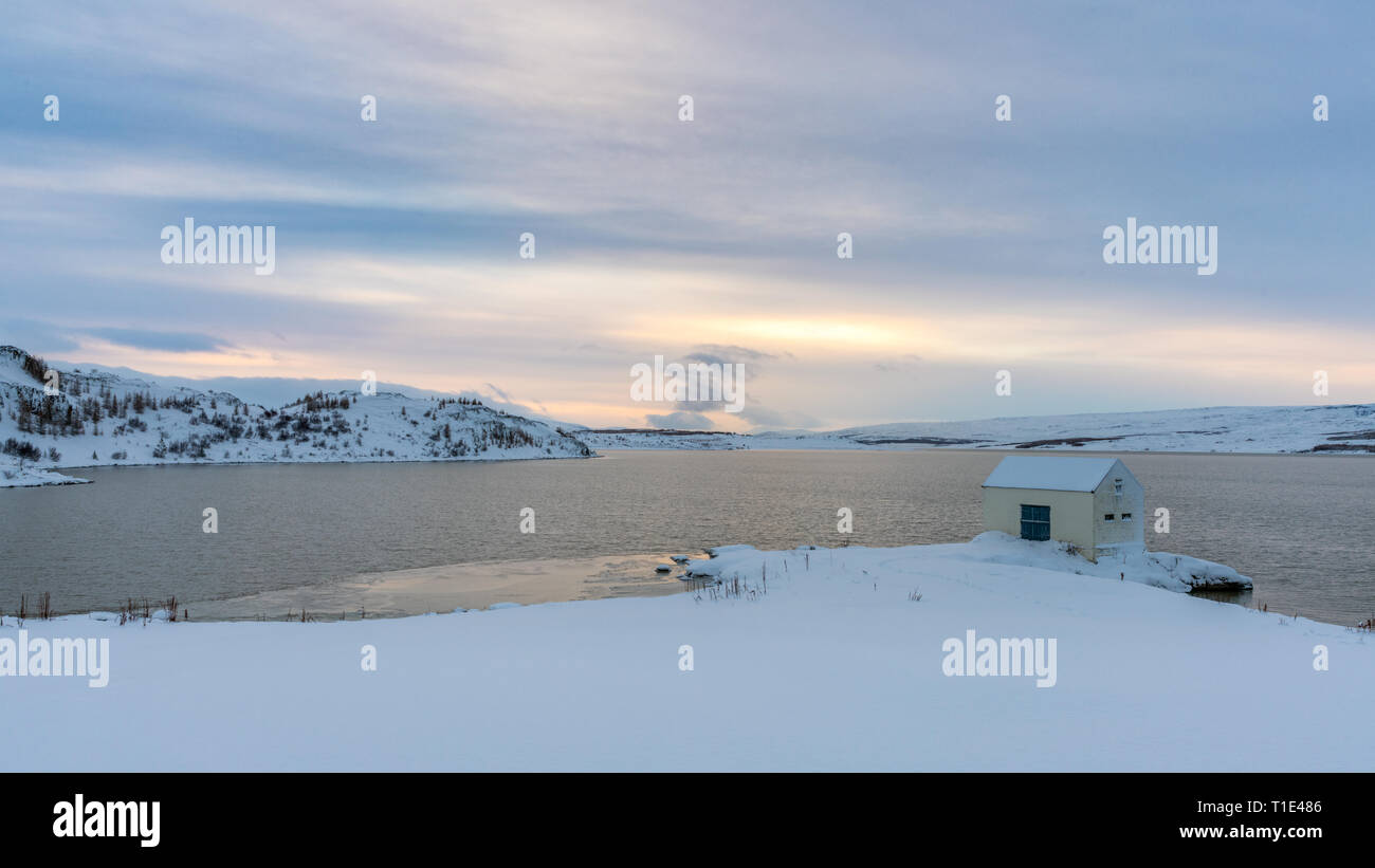 Cabin by a Lake, Snow and Sunset, Iceland in Winter Stock Photo