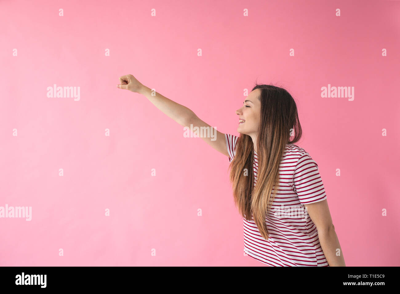 The girl raised her hand forward as if she was flying. Concept of