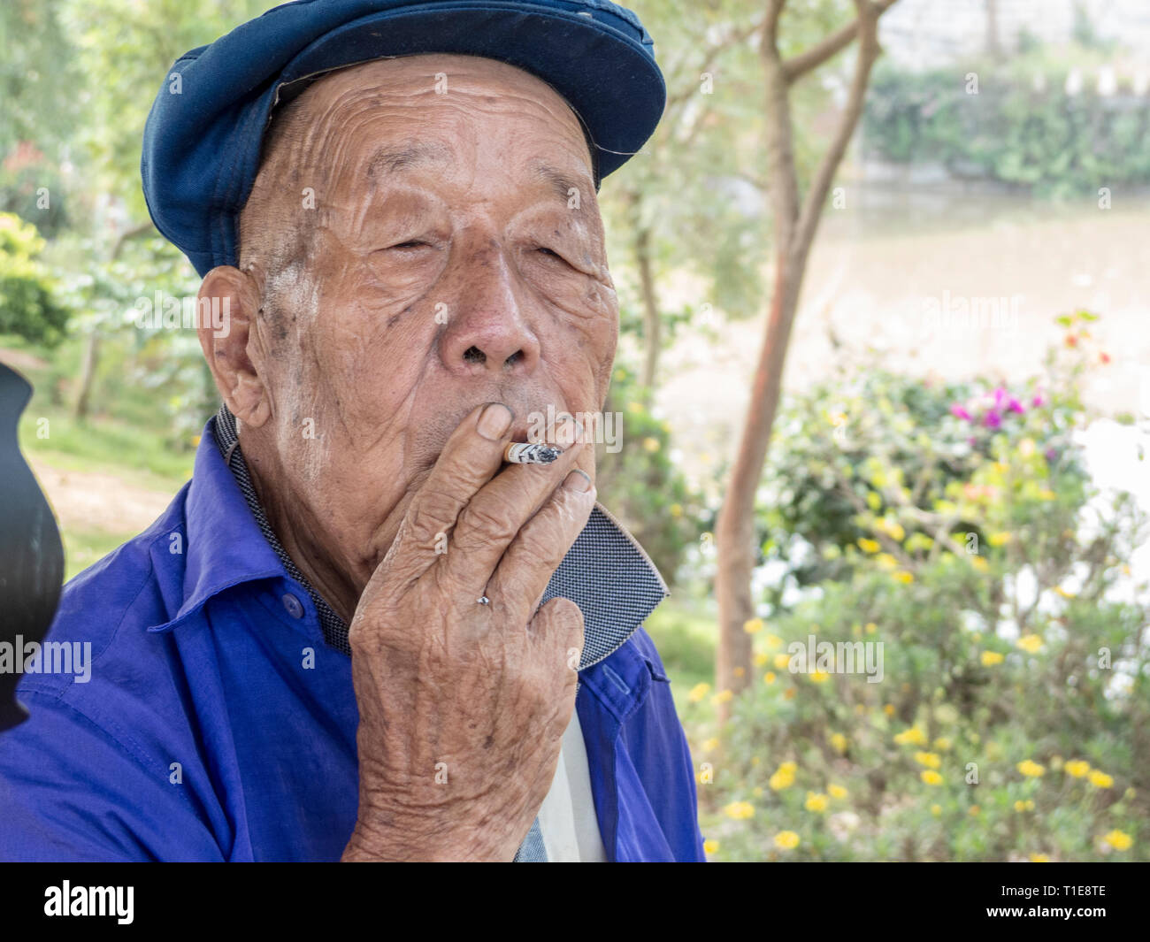 Zigaretten Preis Tattooed Man Smoking Cigarette Near A Window Australia