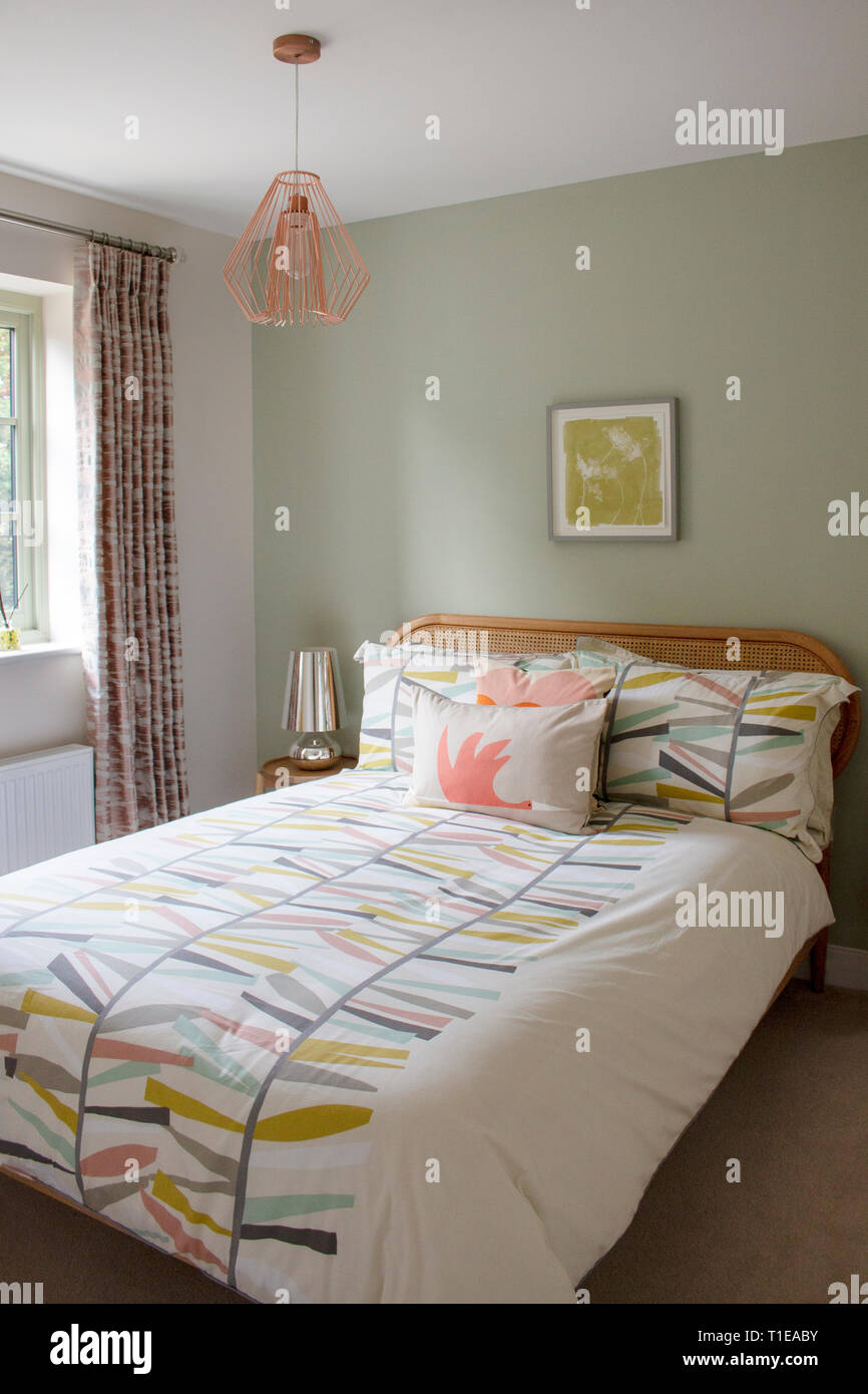 Bedroom made up in vibrant pastel bedding Stock Photo