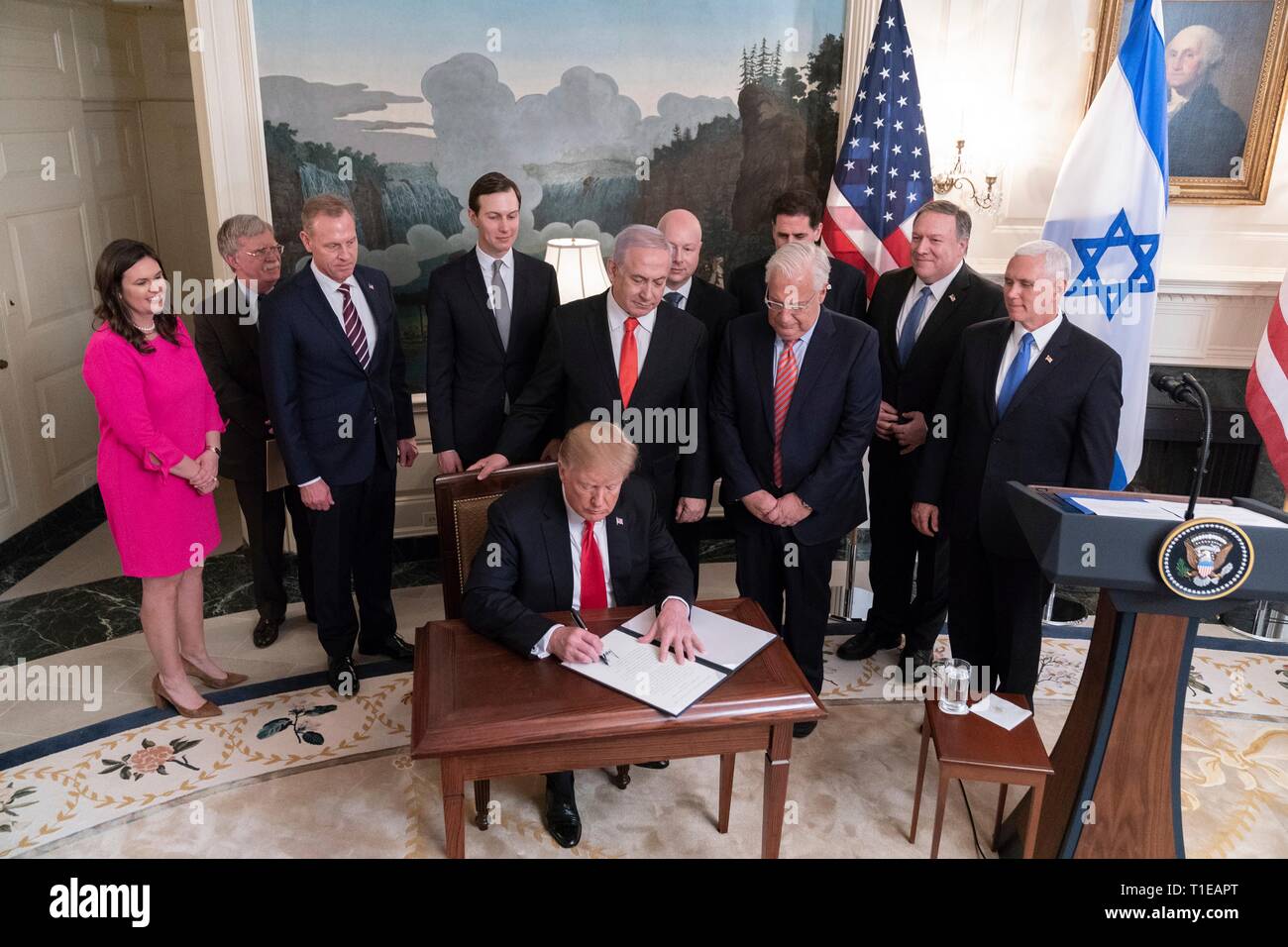 Washington DC, USA. 25th Mar 2019. U.S. President Donald Trump joined by Vice President Mike Pence and Israeli Prime Minister Benjamin Netanyahu signs a proclamation formally recognizing Israeli sovereignty over the Golan Heights in the Diplomatic Reception Room of the White House March 25, 2019 in Washington, D.C. Credit: Planetpix/Alamy Live News Stock Photo