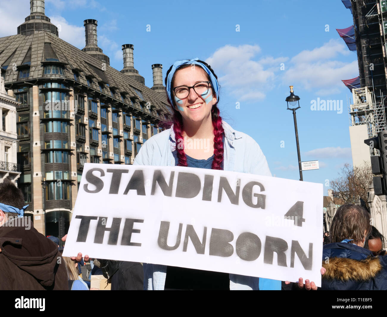 London, UK. 25th March, 2019. A group of young people on a March for Life demonstration on Parliament Square, London, UK and walk to Westminster Bridge for a 9 minutes protest to highlight that since David Steel's Abortion Act 1967, 9 million abortions have been performed in the UK. Credit: Joe Kuis / Alamy Live News Stock Photo