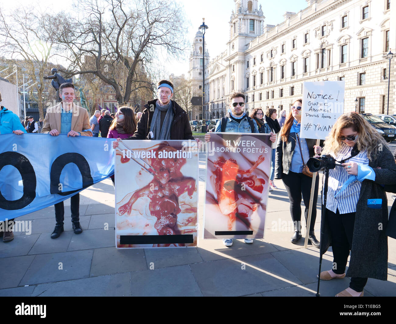 London, UK. 25th March, 2019. A group of young people, on a March for Life, demonstrate on Parliament Square, London, UK and walk to Westminster Bridge for a 9 minutes protest to highlight that since David Steel's Abortion Act 1967, 9 million abortions have been performed in the UK. Credit: Joe Kuis / Alamy Live News Stock Photo