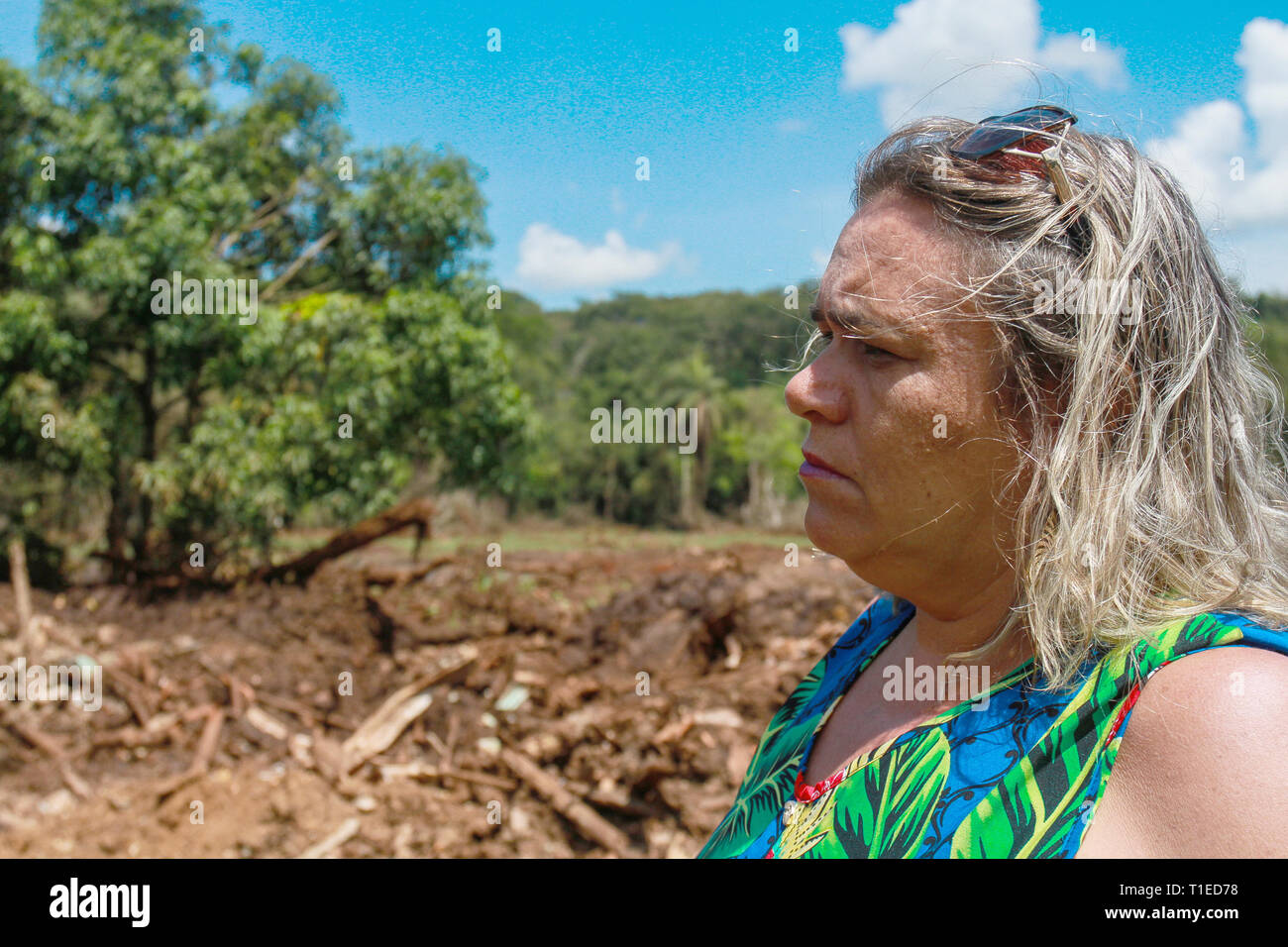 Brumadinho, Brazil. 18th Mar, 2019. Sueli de Oliveira Costa, sales manager, stands on the devastated earth. Her husband, Paulo Giovani dos Santos, died in the breach of the dam on 25.01.2019. The day changed the lives of thousands of people in the small Brazilian town of Brumadinho. Two months later, anger, grief and despair rule. (to dpa 'Everything is gone' - inhabitants of Brumadinho suffer from perineal tragedy') Credit: Rodney Costa/dpa/Alamy Live News Stock Photo