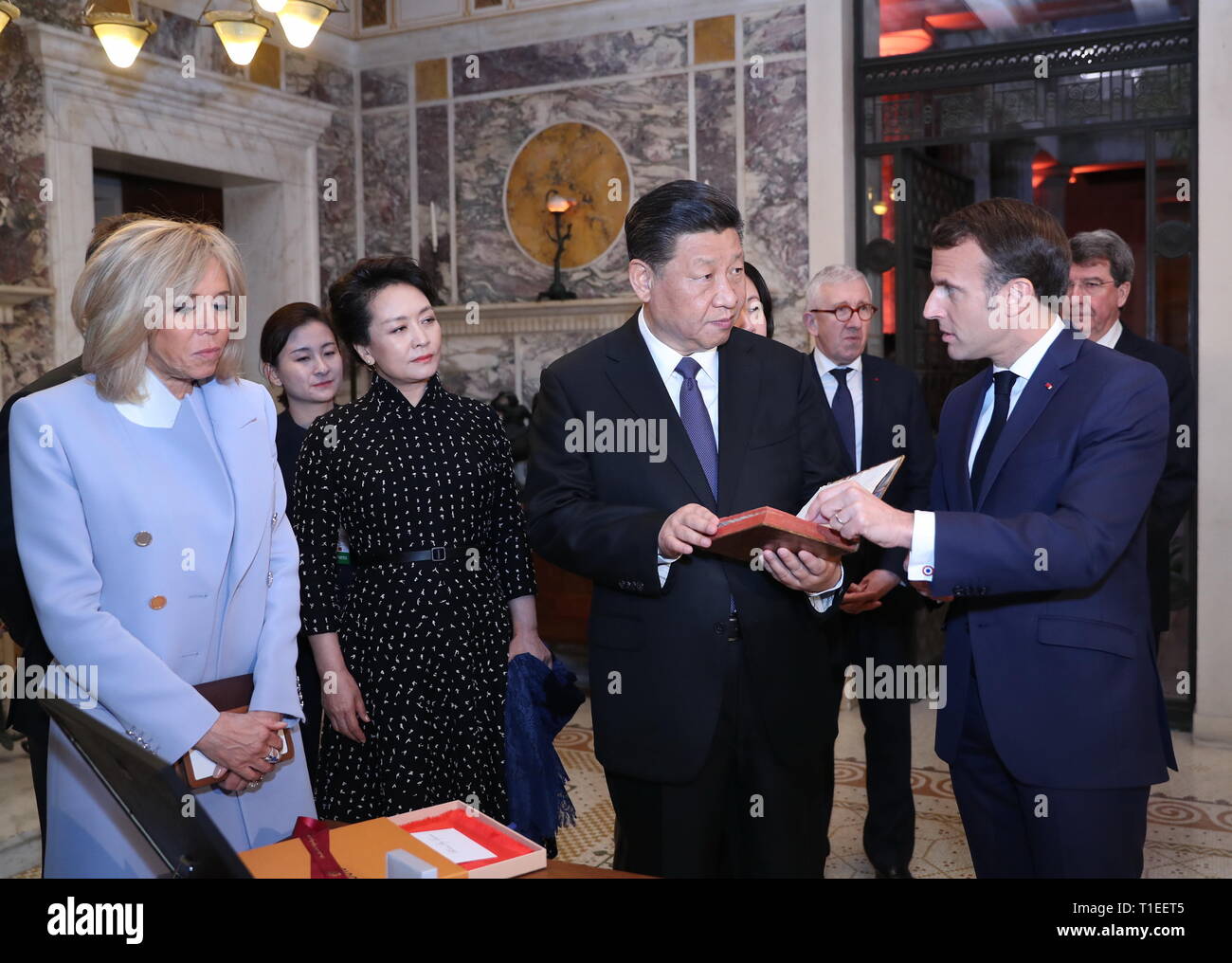 Paris, France. 24th Mar, 2019. Chinese President Xi Jinping (2nd R) receives the original French version of 'An Introduction to The Analects of Confucius', published in 1688, from his French counterpart Emmanuel Macron (1st R), as a national gift before their meeting in Nice, France, on March 24, 2019. Credit: Ju Peng/Xinhua/Alamy Live News Stock Photo