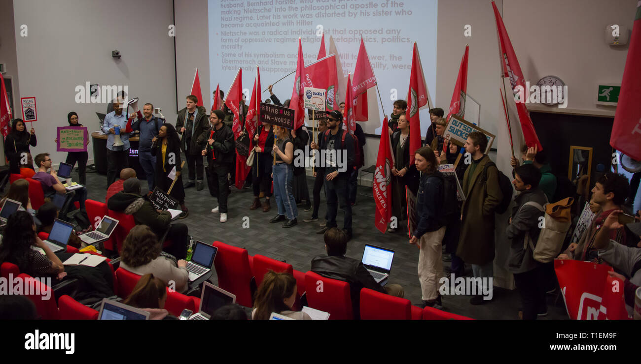 London, UK. 26 March, 2019. Security Officers and supporters at Goldsmiths College in South London marched through the campus where they addresses students in canteens and lecture theatres before taking to the streets to continue the campaign for jobs to be brought ‘in house' so that terms and conditions match those of staff directly employed by the college. David Rowe / Alamy Live News. Stock Photo