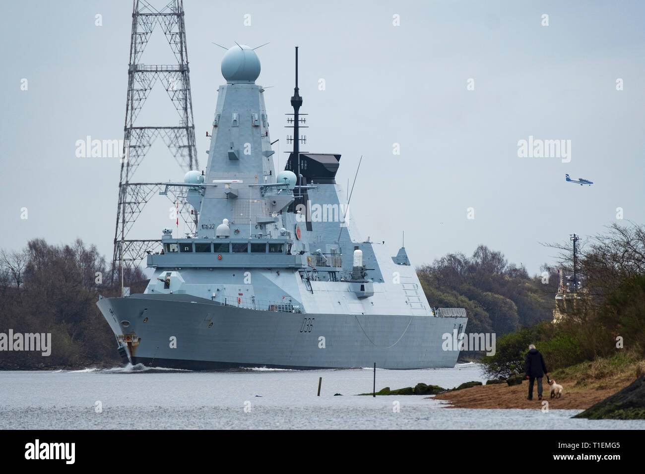 Erskine, Scotland, UK. 26th Mar, 2019. HMS Defender, a Type 45 Destroyer, leaves Glasgow and sails to sea on the River Clyde under the Erskine Bridge after her first home visit in 5 years. Built at Govan on the Clyde, HMS Defender will now join Exercise Joint Warrior, a multi national military exercise off the west coast of Scotland. Credit: Iain Masterton/Alamy Live News Stock Photo