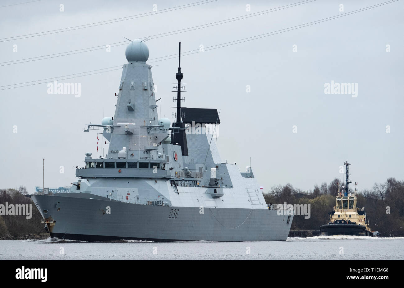 Erskine, Scotland, UK. 26th Mar, 2019. HMS Defender, a Type 45 Destroyer, leaves Glasgow and sails to sea on the River Clyde under the Erskine Bridge after her first home visit in 5 years. Built at Govan on the Clyde, HMS Defender will now join Exercise Joint Warrior, a multi national military exercise off the west coast of Scotland. Credit: Iain Masterton/Alamy Live News Stock Photo