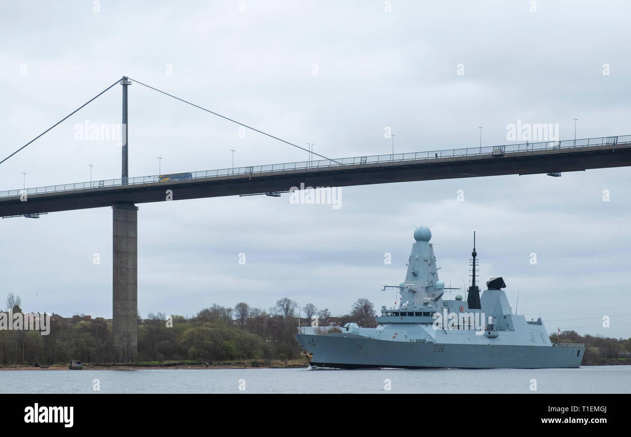 Erskine, Scotland, UK. 26th Mar, 2019. HMS Defender, a Type 45 Destroyer, leaves Glasgow and sails to sea on the River Clyde under the Erskine Bridge after her first home visit in 5 years. Built at Govan on the Clyde, HMS Defender will now join Exercise Joint Warrior, a multi national military exercise off the west coast of Scotland. Credit: Iain Masterton/Alamy Live News Stock Photo