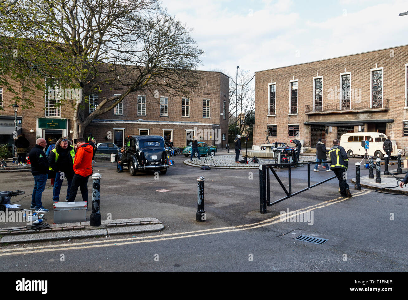 Crouch End, London, UK. 26th March 2019.  A production crew film a scene for 'Pennyworth', an upcoming American drama TV series featuring the early life of Batman's faithful butler Alfred. The art deco town hall is a popular location for film and TV productions. Credit: Michael Heath/Alamy Live News Stock Photo