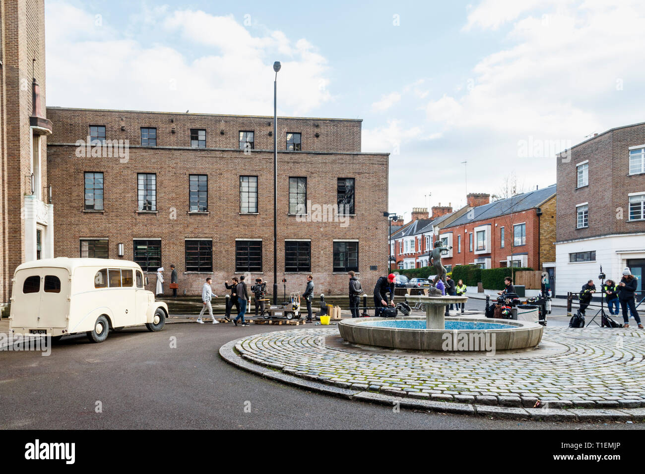 Crouch End, London, UK. 26th March 2019.  A production crew film a scene for 'Pennyworth', an upcoming American drama TV series featuring the early life of Batman's faithful butler Alfred. The art deco town hall is a popular location for film and TV productions. Credit: Michael Heath/Alamy Live News Stock Photo